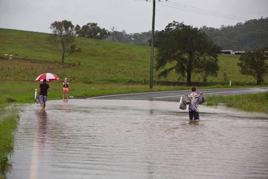 Kim Grimley sent in this photo of residents getting groceries to a family before the flooding became worse on Yandina Creek Rd at North Arm. Picture: Kim Grimley