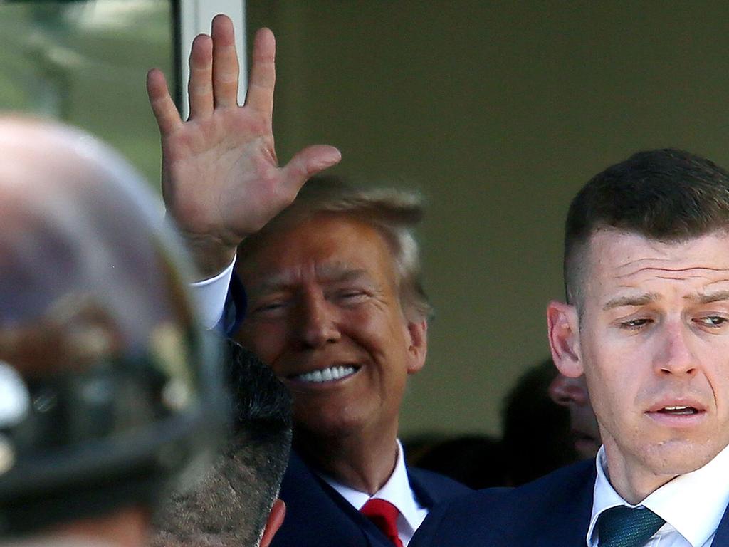 Donald Trump waves as he makes a visit to the Cuban cafe Versailles after he appeared for his arraignment in Miami, Florida. Picture: GETTY IMAGES NORTH AMERICA / Getty Images via AFP