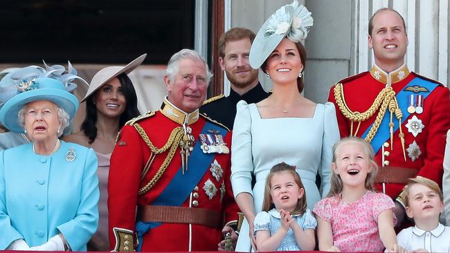 All in the family: Queen ElizabethI, Meghan, Prince Charles, Prince Harry, the Duchess of Cambridge (with Princess Charlotte and Prince George) and Prince William stand on the balcony of Buckingham Palace/