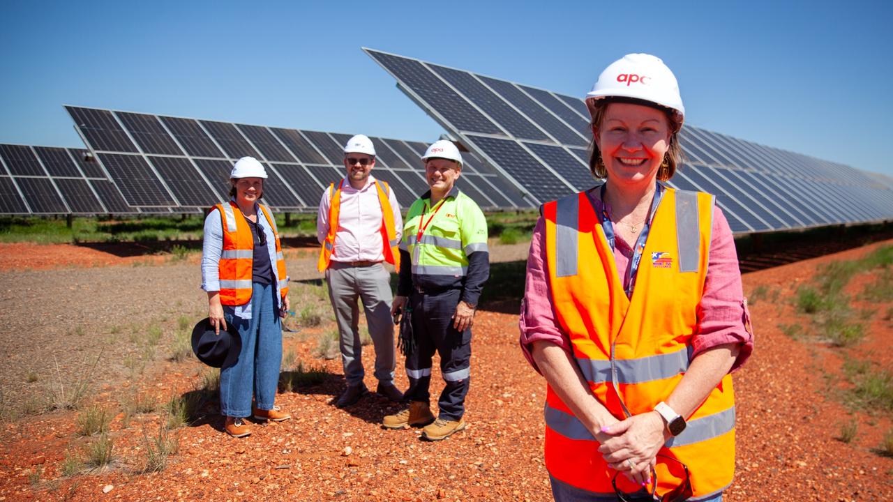 (Front) Mayor Peta MacRae with (back L-R) The Next Economy's Lizzie Webb, Mount Isa Council's Chad King and APA's Sam Floriani at a new solar farm outside town. APA is currently the only energy producer in town.