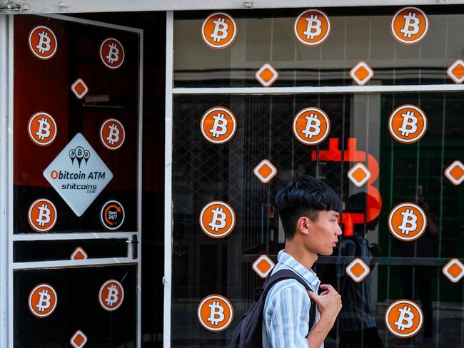 A man walks past a store advertising Bitcoin ATMs in Nicosia on September 25, 2024. (Photo by Jewel SAMAD / AFP)