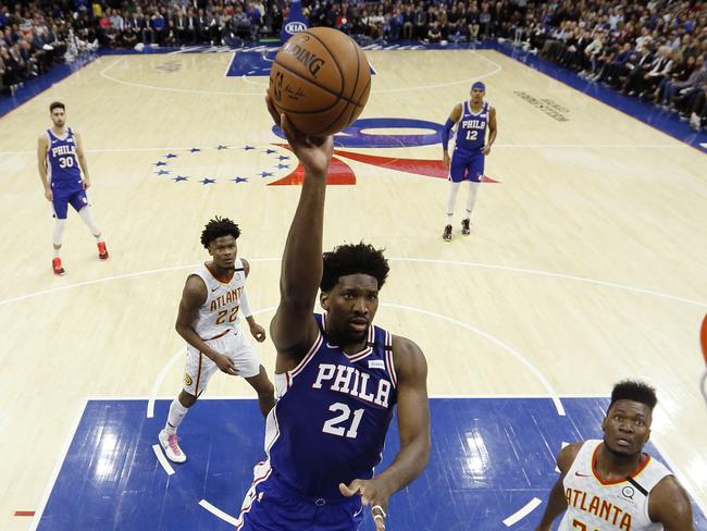 Philadelphia 76ers' Joel Embiid (21) goes up to shoot during the first half of an NBA basketball game against the Atlanta Hawks, Monday, Feb. 24, 2020, in Philadelphia. (AP Photo/Matt Slocum)