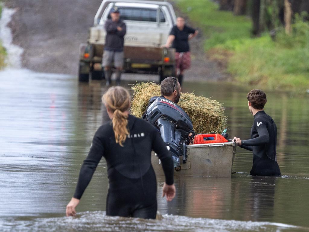 The floods have closed the roads into around Taree neighbours are using boats to cross roads and bring supplies to people trapped by the flood waters.Picture Thomas Lisson