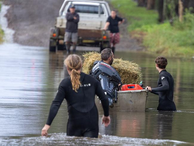 The floods have closed the roads into around Taree neighbours are using boats to cross roads and bring supplies to people trapped by the flood waters.Picture Thomas Lisson