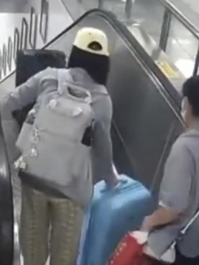 The couple are loading suitcases on to the escalator. Picture: Twitter