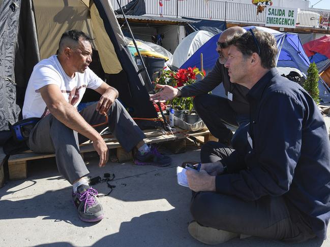 Stewart talking to a Mexican refugee in the border camps.