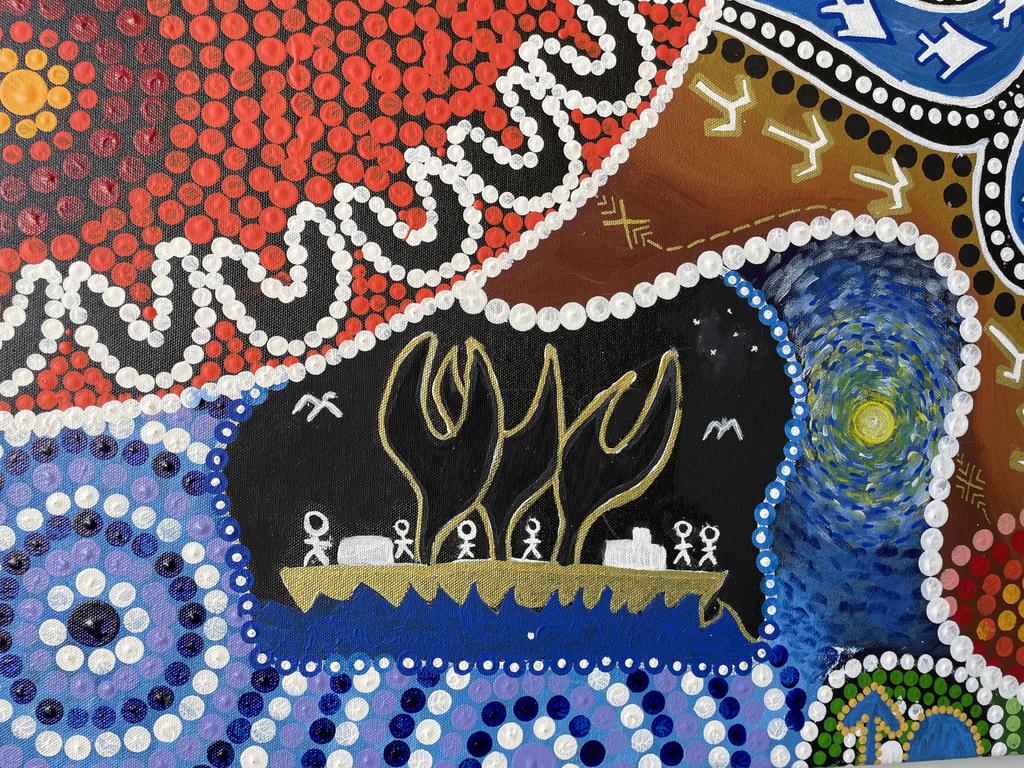 Part of a man's painting, displaying a boat his ancestors used to travel across Northern Australia and into Asia on trading routes. Above is a section of Chris Gray's art which contains a ring of people (the 'U' shapes), representing Mates4Mates as a meeting place for everyone.