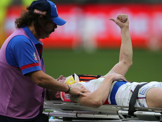 Mitch Honeychurch gives the thumbs up to the spectators while being carted from the field. Picture: Getty Images