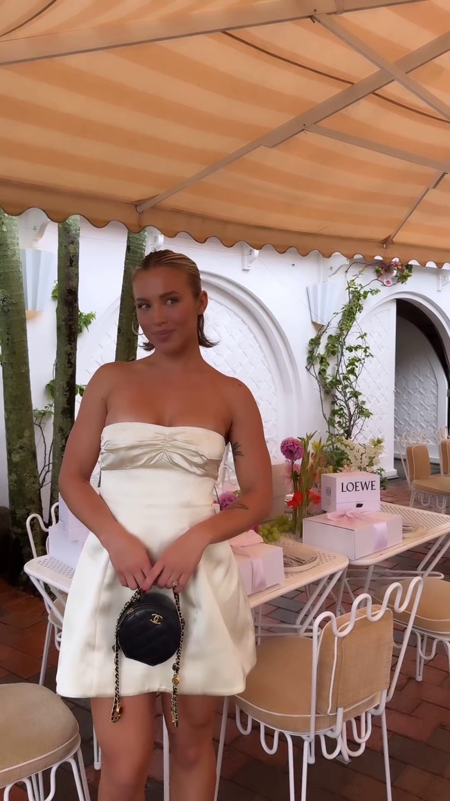 Tammy Hembrow wore a $450 white satin strapless mini dress from Revolve and a $4000 black leather Chanel purse to the lunch. Photo: Instagram.