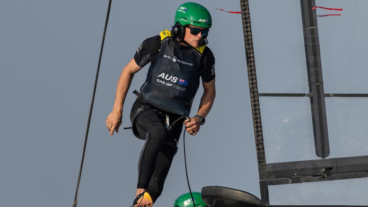 A light-footed Chris Draper, wing trimmer of Australia SailGP Team, runs across the F50. Photo: Felix Diemer for SailGP.