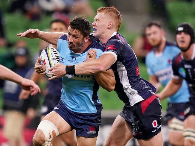 Jake Gordon of the Waratahs is tackled by Campbell Magnay of the Rebels during the Round 3 Super Rugby match between the Melbourne Rebels and NSW Waratahs at AAMI Park in Melbourne, Friday, February 14, 2020. (AAP Image/Scott Barbour) NO ARCHIVING, EDITORIAL USE ONLY