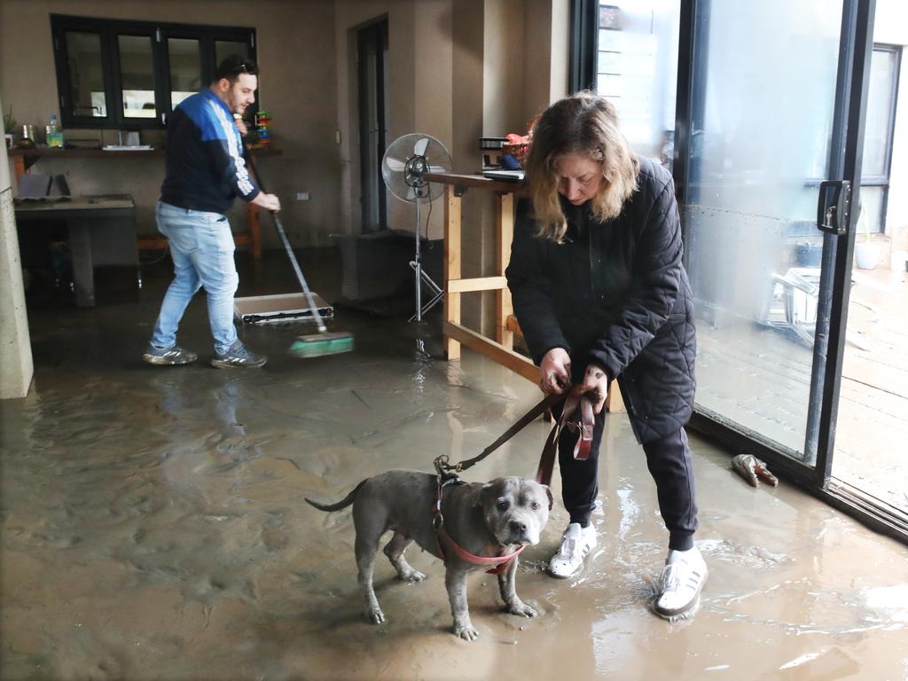 Ali Ulfet cleans out his mothers house where Missy spent the night cowering on a table. Picture: David Crosling