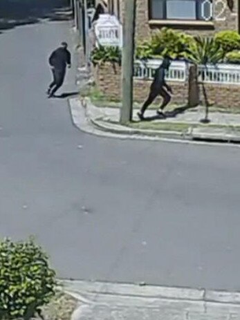 Police pieced together thousands of hours of security footage. Here two people dressed in black flee the scene.