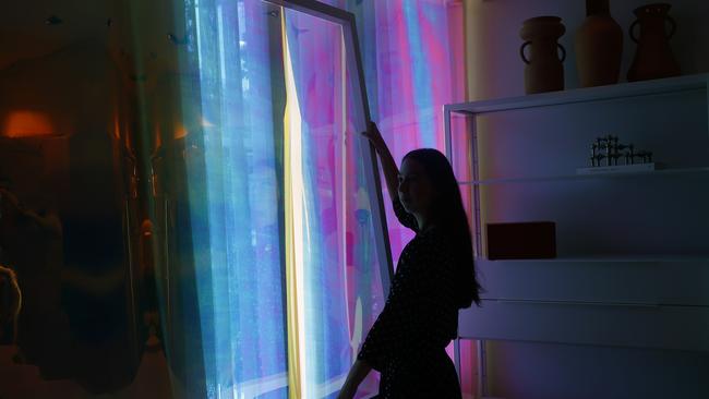 Light shines through the Messoni home colour film as Ellen Simmons works on the Messoni Home Installation at Infinite Design Studio in Woollahra. Picture: John Appleyard