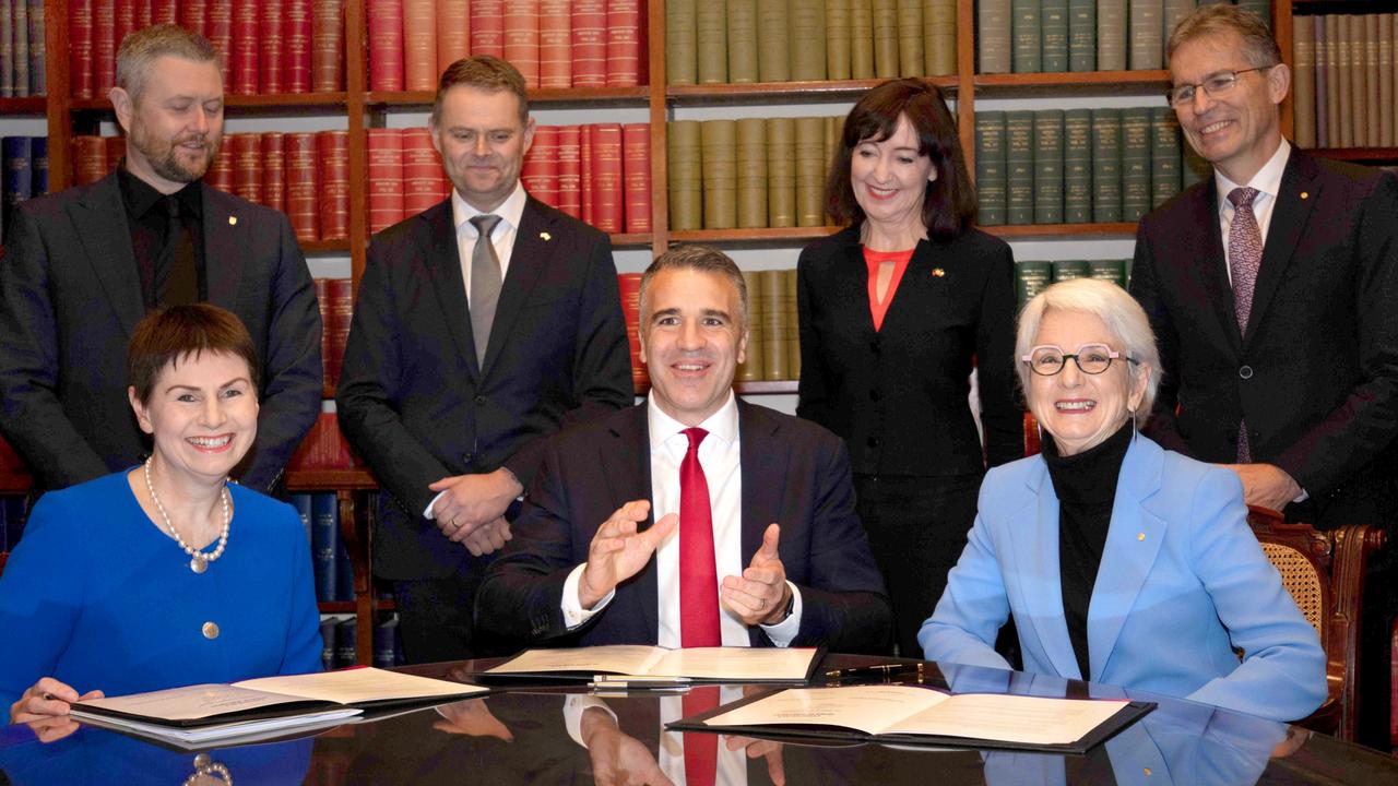 (Front L to R) Chancellor of the University of SA Pauline Carr, Premier Peter Malinauskas, Chancellor of the University of Adelaide Catherine Branson in July, 2023, sign a historic agreement for the creation of the new merged university. Picture: Emma Brasier