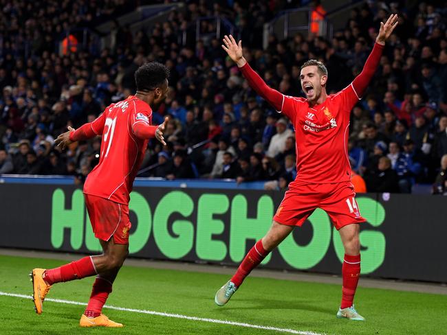 Jordan Henderson (R) of Liverpool celebrates with teammate Raheem Sterling after scoring his team's third goal at Leicester.