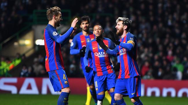 Lionel Messi of Barcelona (R) celebrates scoring.