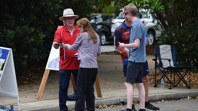 Mundingburra candidates Les Walker offers how-to-vote cards to voters. Photo: Daniel Shirkie.