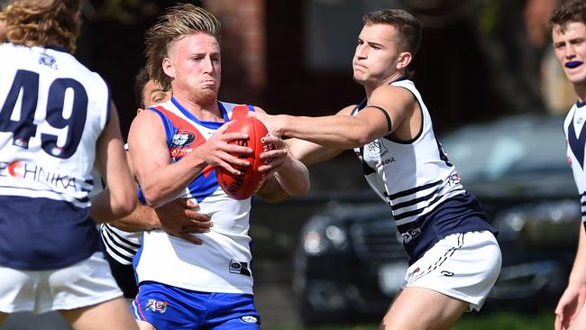 Max Dreher tries to get a kick away. Picture: Steve Tanner