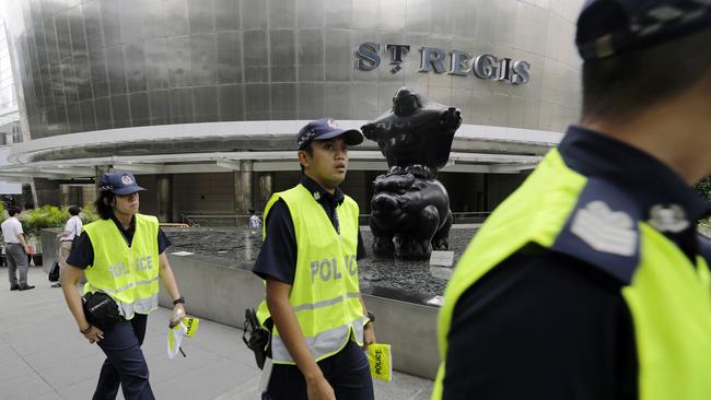 Singapore police patrol the grounds around the St Regis Hotel in preparation for the leaders’ summit tomorrow. Picture: AP