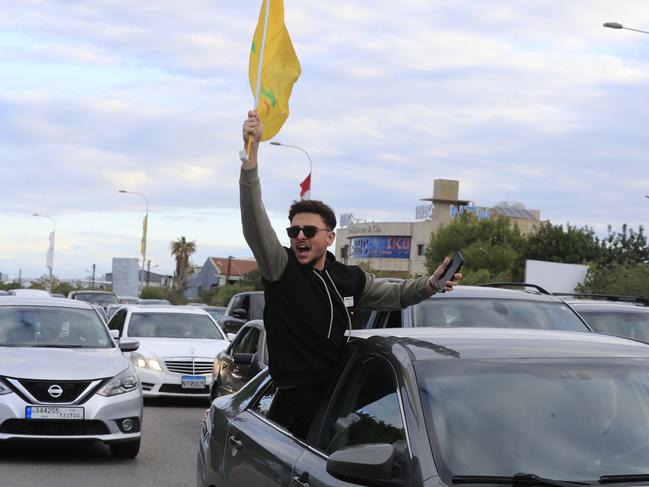 A man carries a Hezbollah flag as he celebrates a ceasefire between Israel and Hezbollah in Ghazieh, Lebanon. Picture: AP