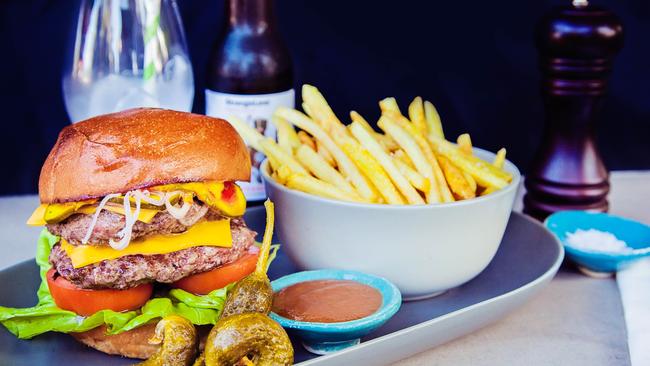 The Wolfe Burger ($16.50) has a house-minced patty topped with cheese, zuni pickle, tomato, butter leaf, eschallot, mustard, tomato and ketchup served on a milk bun with fries. Picture: Wolfe &amp; Co