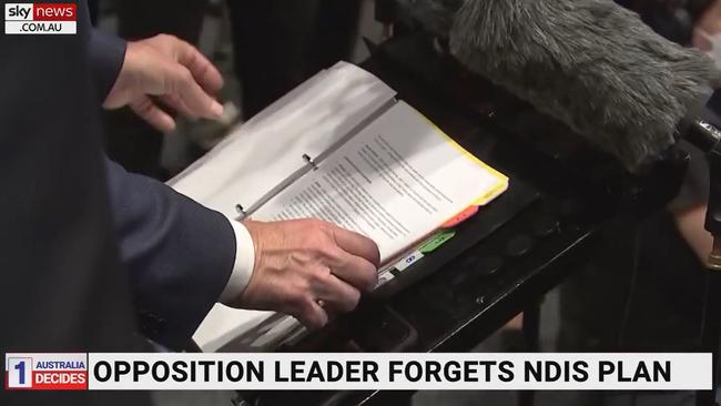 Labor leader Anthony Albanese flicks through a folder during a press conference at which he was questioned about the NDIS. Picture: Sky News