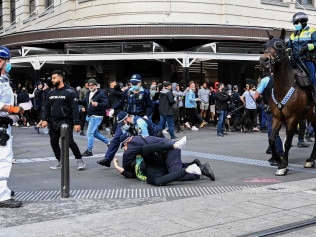 Protestors clash with NSW Police officers at Town Hall during a protest to rally for freedom of speech, movement, choice, assembly and health in Sydney. Picture: NCA