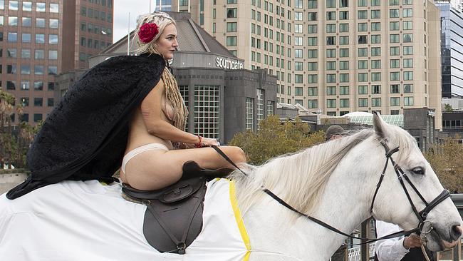 Sarah Keecher, dressed as Lady Godiva, rides through Melbourne’s CBD today as oart of a climate change protest. Picture: Ellen Smith/AAP