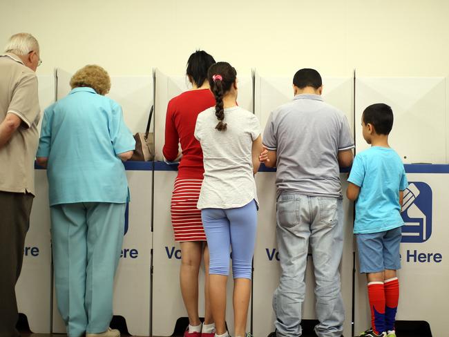 People voting in the state election at Currins Hill Public School. Picture: Jonathan Ng