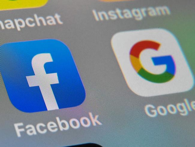 (FILES) In this file photo taken on October 01, 2019 a picture taken on October 1, 2019 in Lille shows the logos of mobile apps Facebook and Google displayed on a tablet. - More than 100 child protection organizations February 6, 2020 urged Facebook to halt plans for strong encryption of all its platforms, saying that would allow predators to operate freely. The social network is working to extend end-to-end encryption across its messaging applications, including Facebook Messenger and Instagram. (Photo by DENIS CHARLET / AFP)