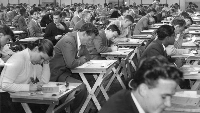 Students concentrate at the opening sitting of University exams at Centennial Hall, Wayville, in 1957. Second from left in the front row is medical student and Sturt footballer Angus Ellis.