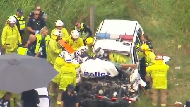 Emergency crews working to retrieve Senior Constable Chris Leonard from his vehicle after the crash. Picture: 9 News