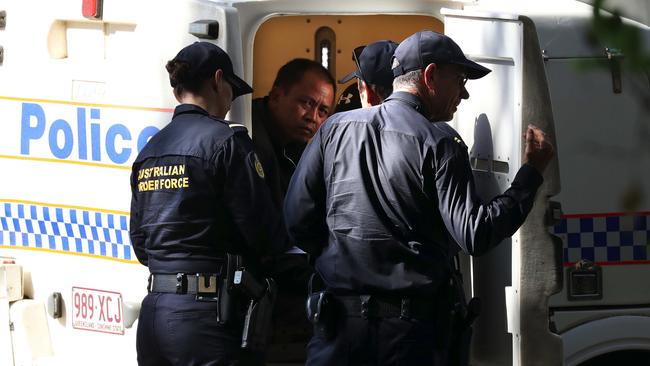 A captured Vietnamese asylum seeker in the back of a police van at Cape Kimberley. Picture: Marc McCormack