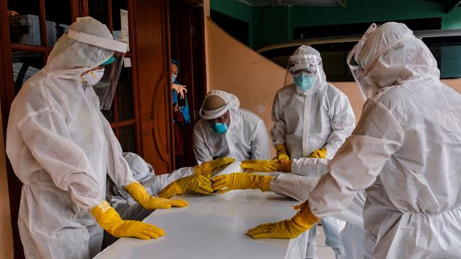 Public safety officers seal the casket of a man suspected to have died of Covid-19 in Jakarta on Tuesday. Picture: Getty Images