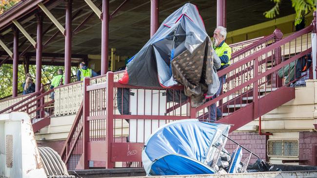 Council workers throw out squatters' possessions. Picture: Jake Nowakowski