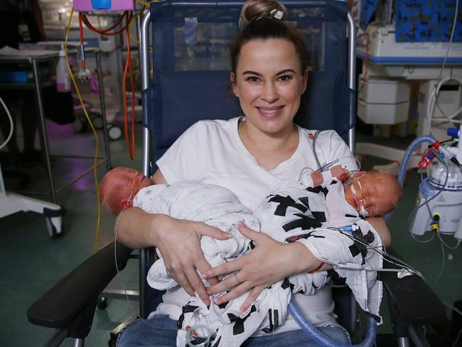Lauren Symons, 33, of Wollongong holds bother her newborn twins Neiko (left) and Jenson for the first time. Picture: Sam Ruttyn
