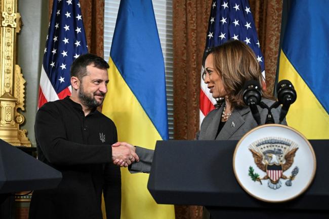 US Vice President and Democratic presidential candidate Kamala Harris (R) and Ukraine's President Volodymyr Zelensky shake hands after speaking to the press on September 26, 2024