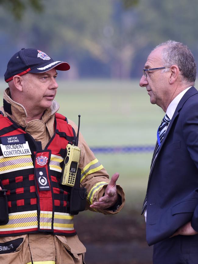 Christ Church Grammar School principal Neil Andary speaks to a fire chief. Picture: Andrew Henshaw