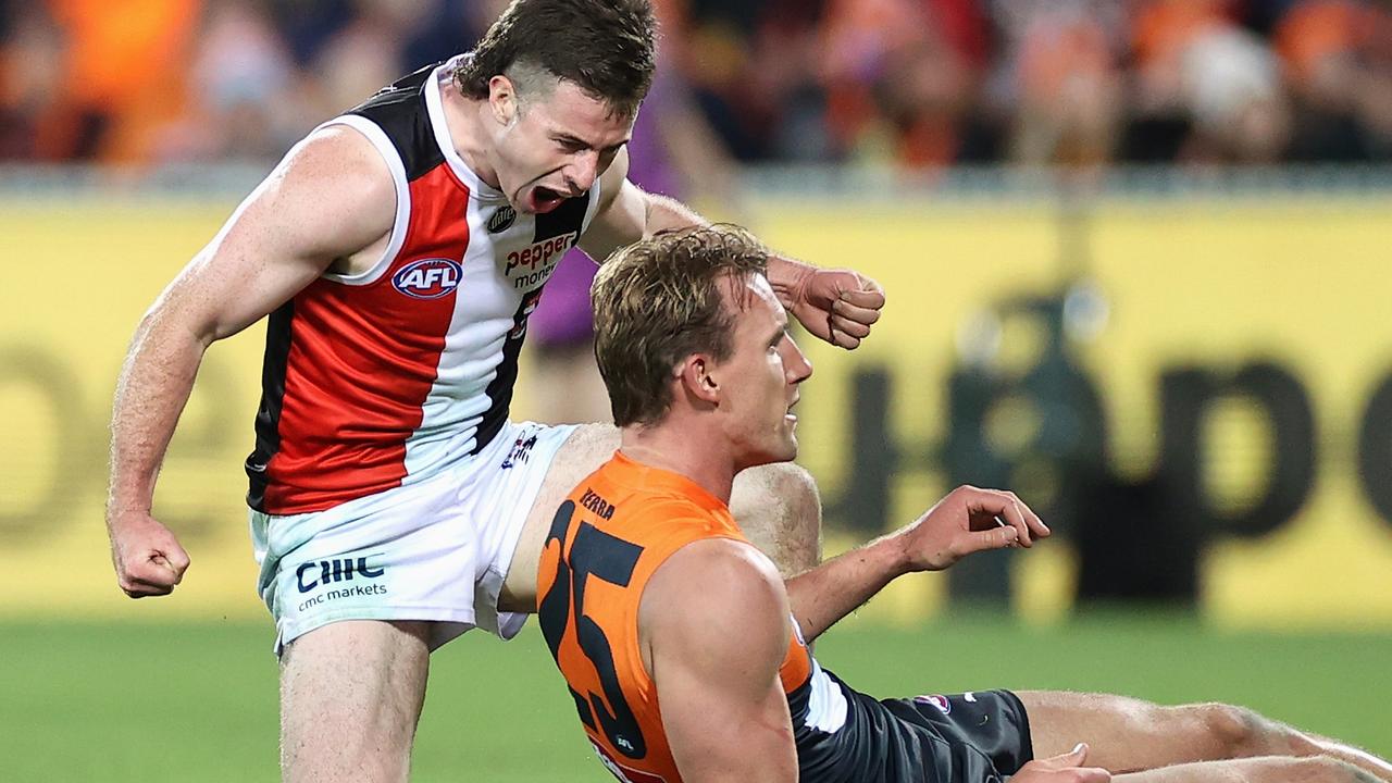 Jack Higgins celebrates kicking a goal over Lachlan Keeffe at Manuka Oval. Picture: Getty Images