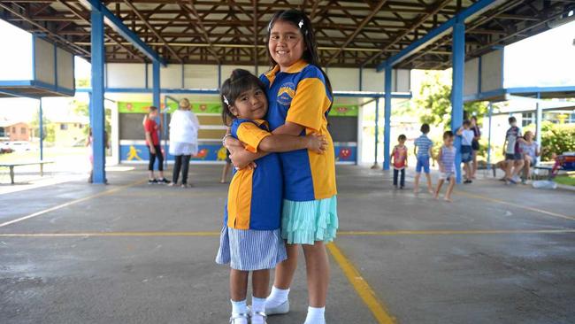 SISTERS IN ARMS: Erika and Emily Williams try their new Mt Archer School uniforms on for size, eagerly waiting for school to start next week. Picture: Jann Houley