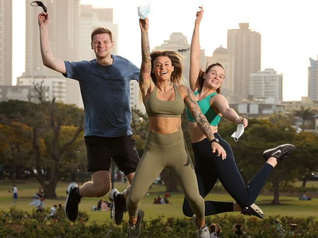 Alex Wicht, 21, Pullenvale, Marisa Mc Elroy, 32, Teneriffe, and Claire Wicht, 24, Toowong, celebrating the end of Covid lockdown. Picture: Liam Kidston