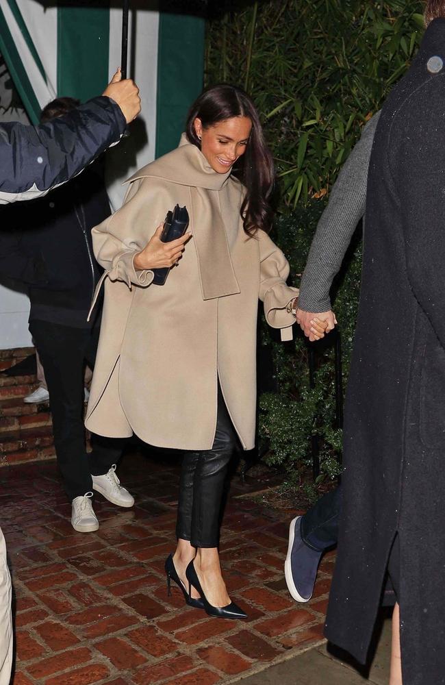 Meghan Markle walks hand-in-hand with Prince Harry as she enters the A-list hangout. Picture: The Daily Stardust / ShotbyNYP/MEGA / BACKGRID