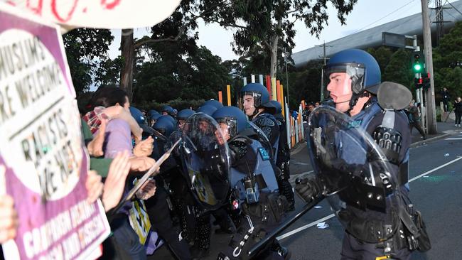 Police in riot gear cordon off protesters. Picture: Jake Nowakowski