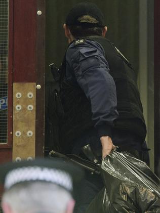 Police from the Tactical Aid Unit enter Granby House apartments in Manchester in connection to Monday's explosion. Picture: Ben Birchall/PA via AP