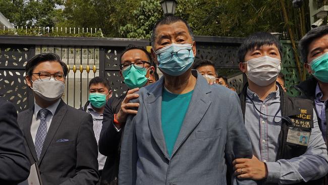 Jimmy Lai, centre, is arrested at his home on Saturday. Picture: AP