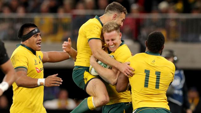 Reece Hodge (centre) of the Wallabies is congratulated by teammates after scoring a try during the Bledisloe Cup match between between the Australian Wallabies and the New Zealand All Blacks at Optus Stadium in Perth, Saturday, August 10, 2019. (AAP Image/Richard Wainwright) NO ARCHIVING, EDITORIAL USE ONLY