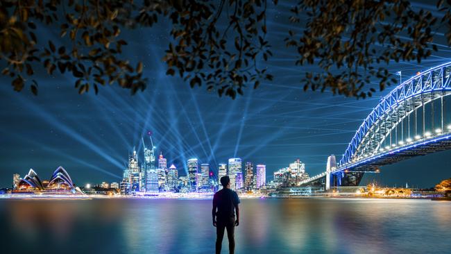 Man watching the City Sparkle light projection and installation on the Sydney Harbour Bridge from Kirribilli during Vivid Sydney 2019. Picture: Amanda Woods