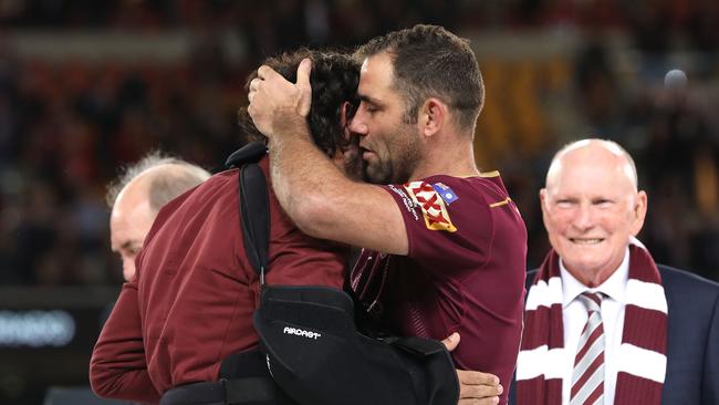 Johnathan Thurston and Cameron Smith embrace on the podium after winning game three of the State of Origin series. Picture: Mark Kolbe/Getty Images