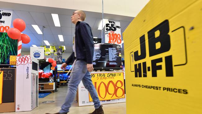 A retail sales assistant is seen inside a JB Hi-Fi store in Brisbane. Picture: Darren England/AAP Image